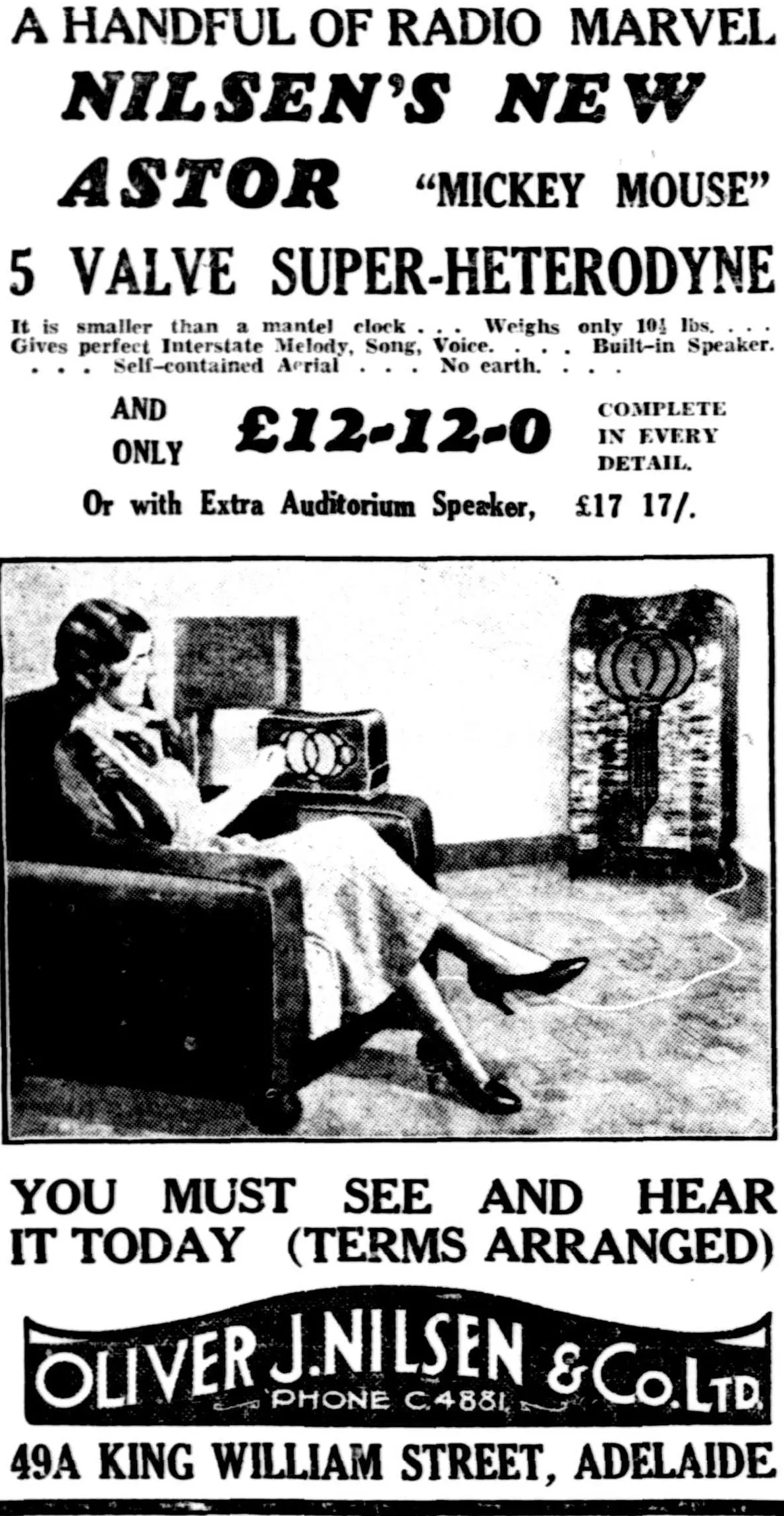 A newspaper advertisement: a handful of radio marvel, Nilsen’s new Astor Mickey Mouse 5 valve super-heterodyne, smaller than a mantel clock, £12-12-0, over a photograph of a woman in an armchair beside the little set, with a big console radio behind her.